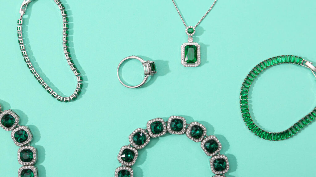green tortoise jewelry laid out on surface same color surface