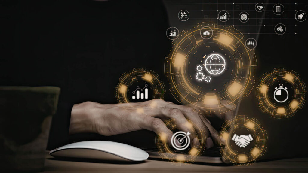 Person using a computer with digital interface icons representing analytics, automation, and AI tools.
