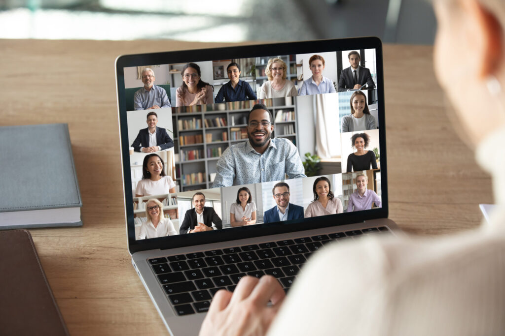 Person on a video call displayed on a laptop during a remote meeting.