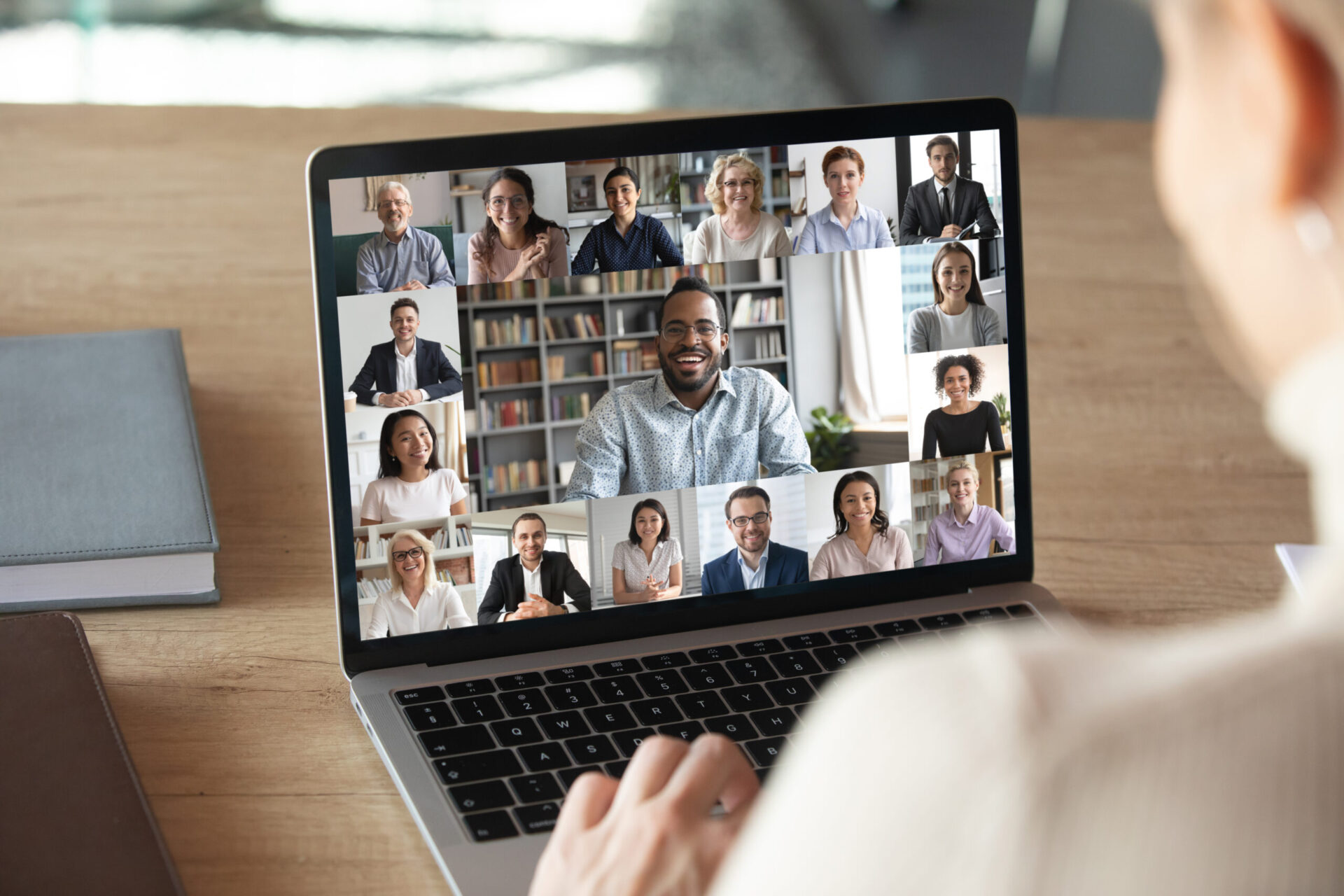Person on a video call displayed on a laptop during a remote meeting.